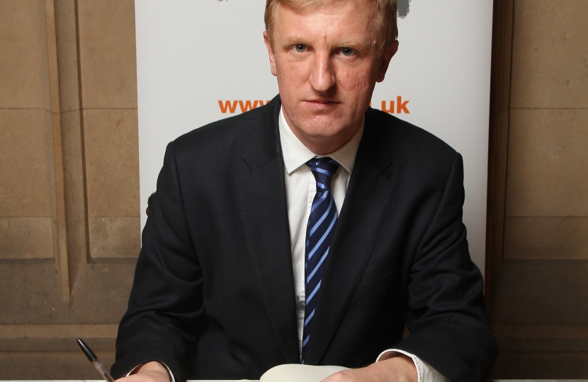 Oliver Dowden MP signing the Holocoaut Memorial Day Book of Committment