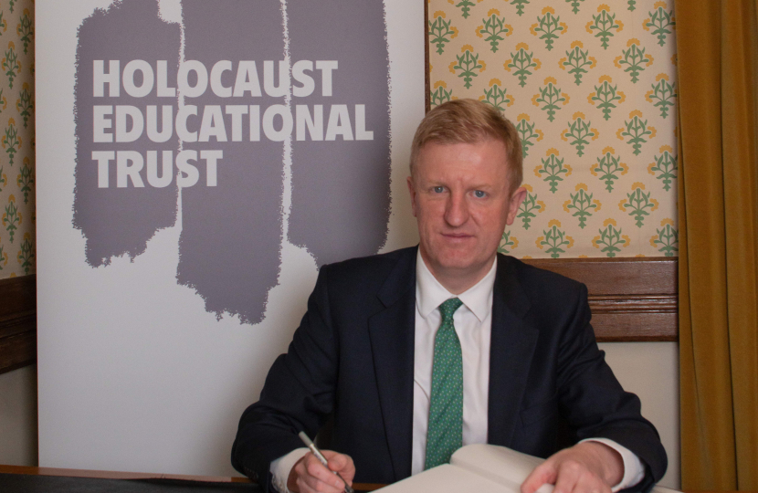 Oliver Dowden signing the Book of Commitment. Photo Credit: Holocaust Educational Trust
