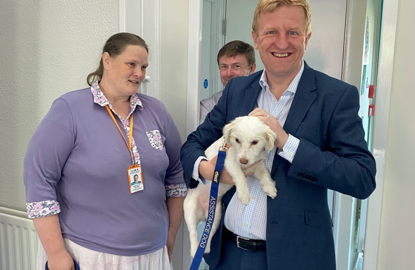 Oliver Dowden with a Communities 1st volunteer and an assistance dog