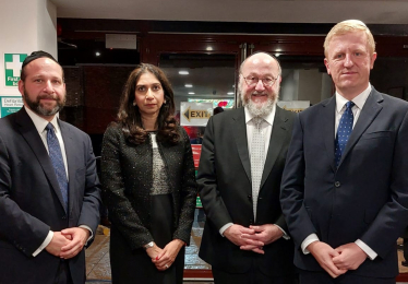 Oliver with (from left to right) with Rabbi Elchonon Feldman of Bushey United Synagogue, Home Secretary Suella Braverman MP and Chief Rabbi Ephraim Mirvis.