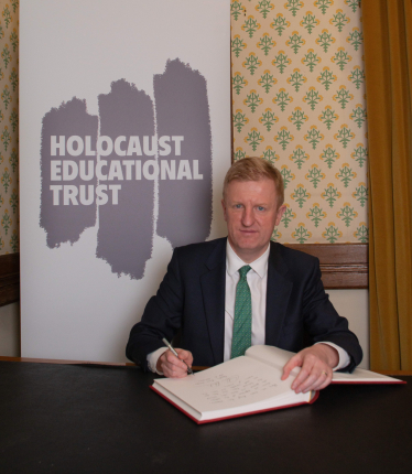 Oliver Dowden signing the Book of Commitment. Photo Credit: Holocaust Educational Trust
